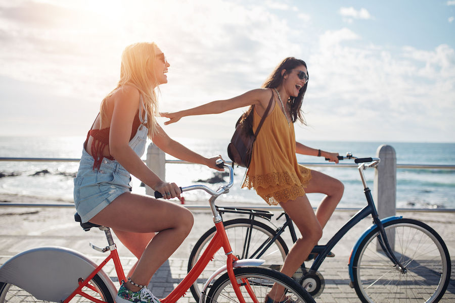 Image of girlfriends riding bicycles together